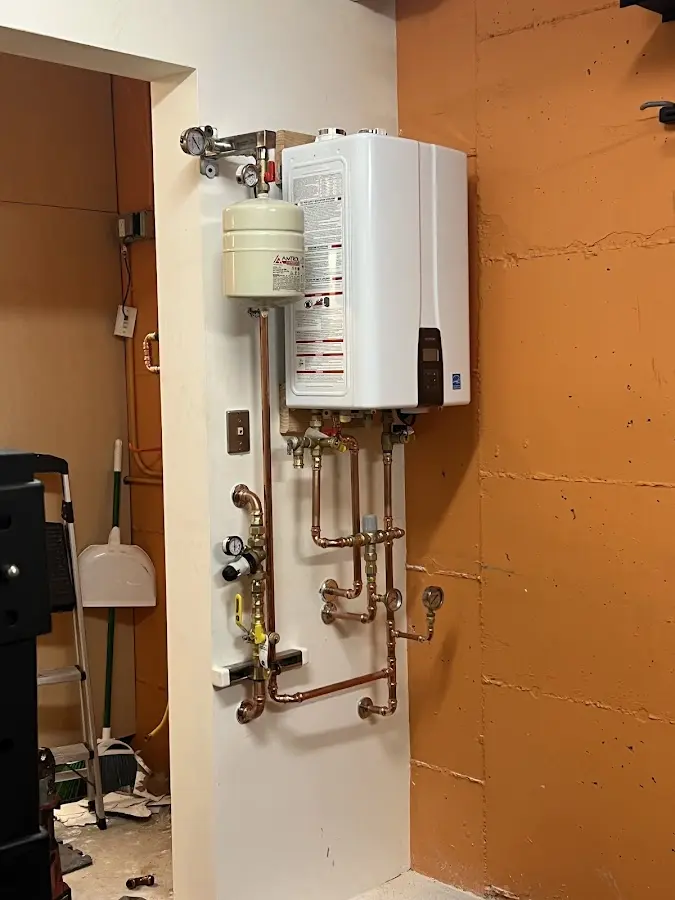 Plumbing technician inspecting water heater connections in San Francisco